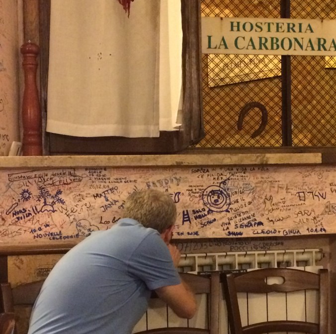 Signing the wall at La Carbonara